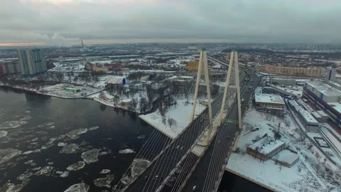 Aerial footage of a cable-stayed bridge, ice moving along the river Stock-Footage 172541277