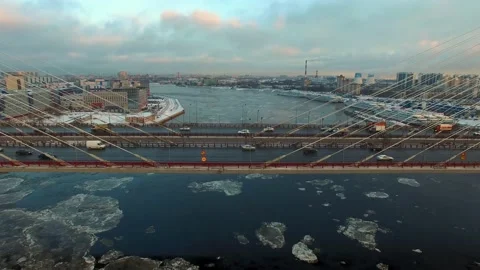 Aerial footage of a cable-stayed bridge, ice moving along the river Stock Footage 172541365