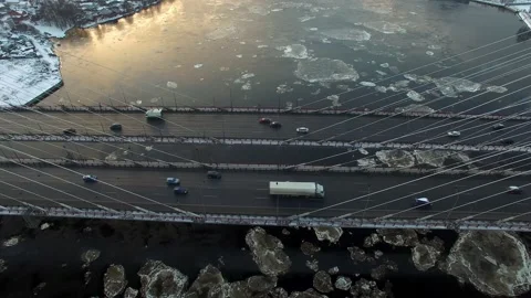 Aerial footage of a cable-stayed bridge, ice moving along the river Stock Footage 172541401