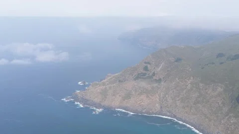 Aerial footage captures the dramatic, rugged coastline and steep cliffs Stock Footage 346703098