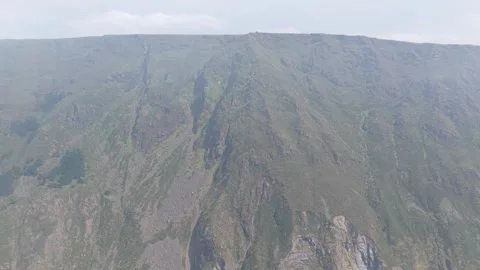 Aerial footage capturing the dramatic, rugged cliffs surrounding Garita da Stock Footage 346721059