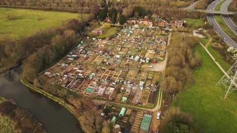Aerial footage descending over a patchwork of vegetable allotme Stock Footage 150979899