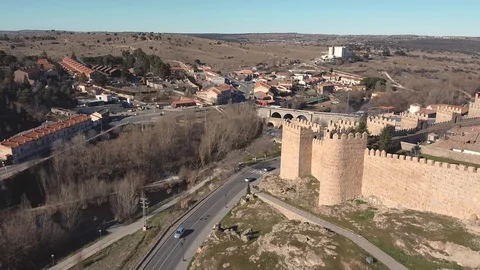 Aerial footage by a drone flying back above the historical Walls of Avila Video stock 123726801