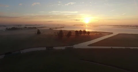 Aerial footage of a in lake in fog during sunrise, the Netherlands Stock Footage