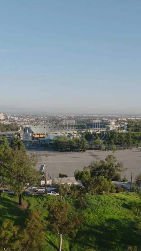 Aerial footage of large empty car park and sports arena. Famous Dodger Stadium a Stock Footage 337415459