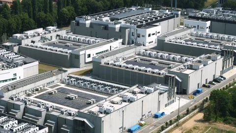 Aerial footage of a large-scale data center complex featuring multiple Stock Footage 336631496