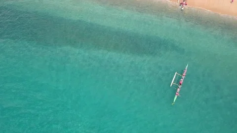 Aerial footage looking down at a group of canoes arriving in Manele bay Stock Footage 131333705