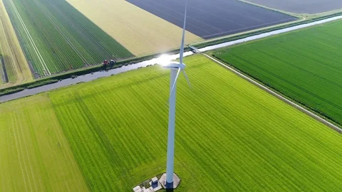 Aerial footage looking down at wind turbine bright summer day 4k Stock Footage 78500770