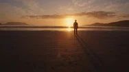 Aerial Footage Of Man Walking On Sea Shore At Beach Stock Footage