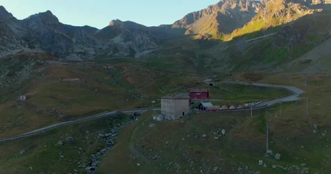 Aerial Footage of mountains casting a shadow on a building in Italy (4K) Stock Footage 187595392