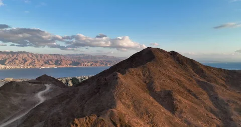 Aerial footage of the mountains of Eilat, In the background eilat city Stock Footage 237494272