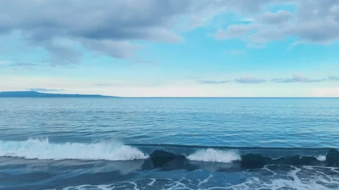 Aerial footage of ocean beach with amazing azure water, blue cloudy sky on Bali Stock Footage 87491753