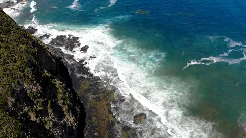 Aerial Footage of Ocean Waves Hitting Rocky Cliffs Stock Footage