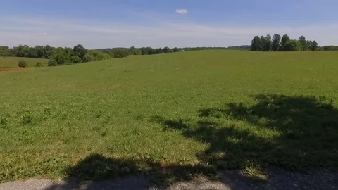 Aerial Footage Over Open Fields on Sunny Day Stock Footage 82046514