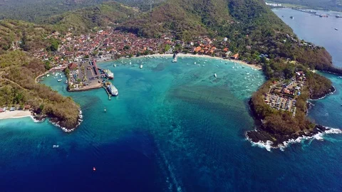 Aerial footage of Padang Bai harbor in Bali, Indonesia with tilt up Stock Footage