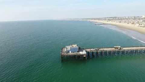 Aerial footage panning around the end of a pier Stock Footage