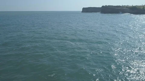 Aerial footage pullback maneuver through rock of Klayar beach Stock Footage 94480142