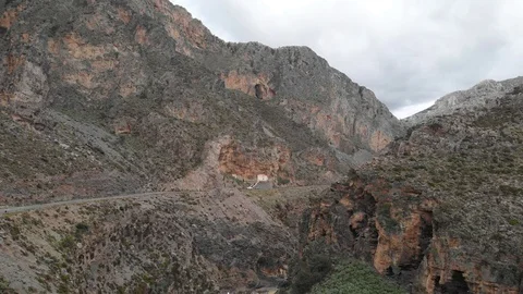 Aerial footage of a road passing through a gorge with mountains in Greece Stock Footage 128190887