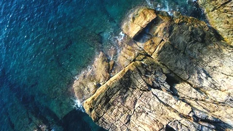 Aerial footage of rocky shoreline at Perhentian Island, Malaysia during sunrise. Stock Footage