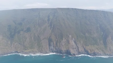 Aerial footage showcasing the dramatic, steep cliffs and rugged coastline around Stock Footage 346672647