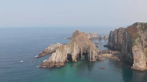 Aerial footage showcasing the rugged cliffs and striking rock formations along Stock Footage 346715282