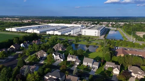 Aerial footage showing a large data center building next to a suburban american Vídeos de archivo 346148026