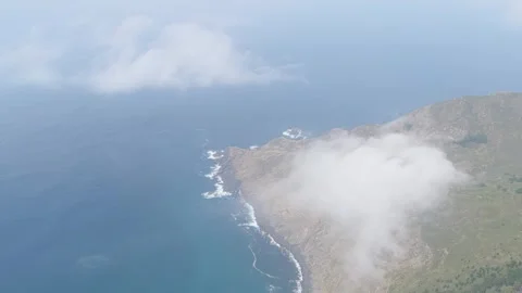 Aerial footage showing the rugged cliffs and dramatic coastline around Garita da Stock Footage 346706363
