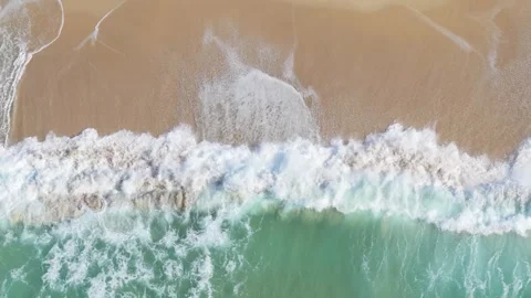 Aerial footage showing waves rolling onto the sandy shore of Praia de Traba Stock Footage 346716154