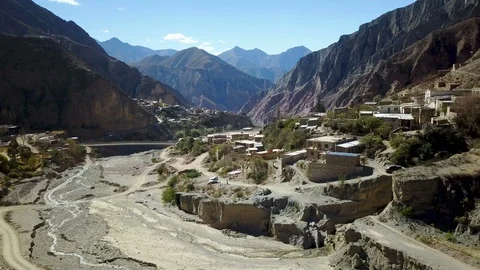 Aerial Footage of Small Village in dry Mountain Desert and empty riverbed Stock Footage