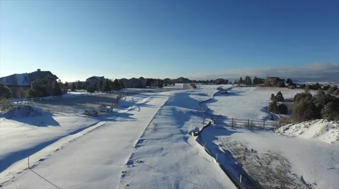 Aerial footage speeding down a private road covered in snow Stock Footage 47404316