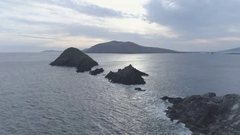 Aerial Footage Of Stack Rocks Amidst Sea During Sunset Stock Footage 79654298