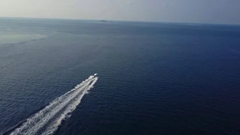 Aerial footage top view with motor boat at high speed cuts the waves while is Stock Footage