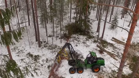 Aerial footage of a tractor pulling a tree in the forest Stock Footage 69965719
