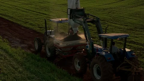Aerial Footage of Tractors Loading Solid Fertilizer in Wheat Field, Brazil Stock Footage 314142788