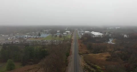 Aerial footage of a train passing through forested landscape 動画素材 313402022