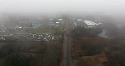 Aerial footage of a train passing through forested landscape 動画素材 313402083