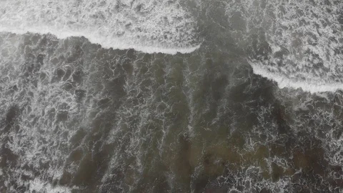 Aerial Footage of waves full of algae and dark water after inflow. Stock Footage 124127779