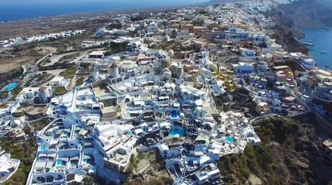 Aerial footage - White houses and blue domes of Oia, Santorini. Stock Footage