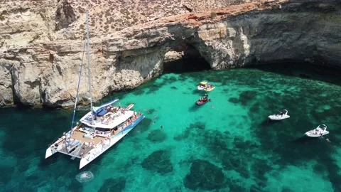 Aerial footage of a yacht in Crystal lagoon, Malta Stock Footage