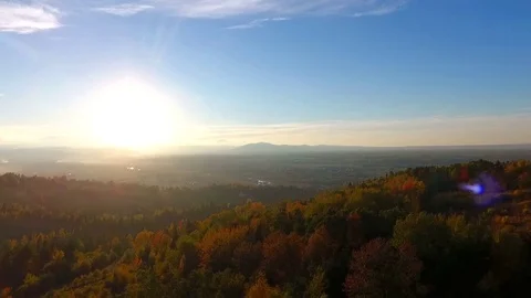 Aerial forest sunset - light touching treetops. Mountains sund dusk. Stock Footage 83127811
