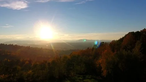 Aerial forest sunset - light touching treetops. Mountains sund dusk. Stock Footage 83127970