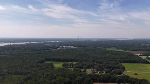 Aerial of forested landscape bordering Ohio river with suburban development Stock-Footage 343592901
