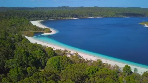 Aerial Forward of Amazing Beach Between Bright Blue Ocean and Lush Green Forest Stock Footage 111887741