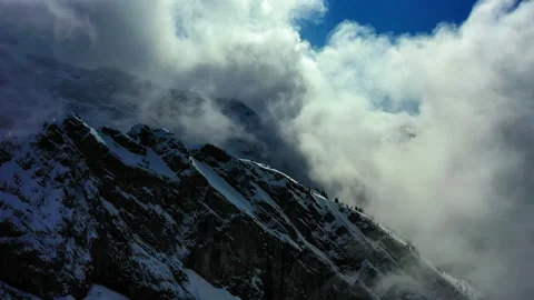 Aerial Forward Beautiful Shot Of Clouds Over Snowy Rock Formations - Savoie, Video stock 167836770