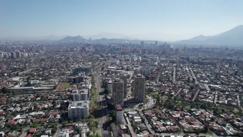 Aerial Forward Drone Shot Over Urban Santiago with Andes Mountains - 4K Stock Footage 344828889