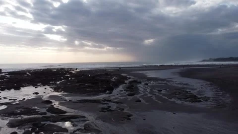 Aerial Forward Flight Over Black Sand Beach in Bali Indonesia Stockbeeldmateriaal 330700759
