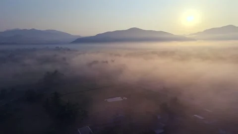 Aerial forward flight over misty rural valley at sunrise 4K 스톡 동영상 334359083