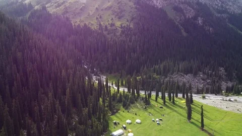 Aerial Forward Flight over Nomad Yurt Camp with Dreamy Lens Flare Video stock 332010365