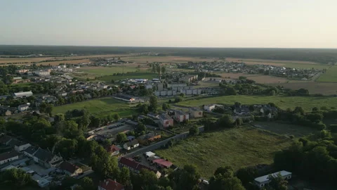Aerial Forward Flight Over Small Town and Fields at Sunset Stock Footage 323768632
