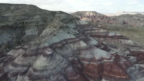 Aerial forward flight with a smooth right turn over bentonite clay hills in Utah Stock Footage 333177382